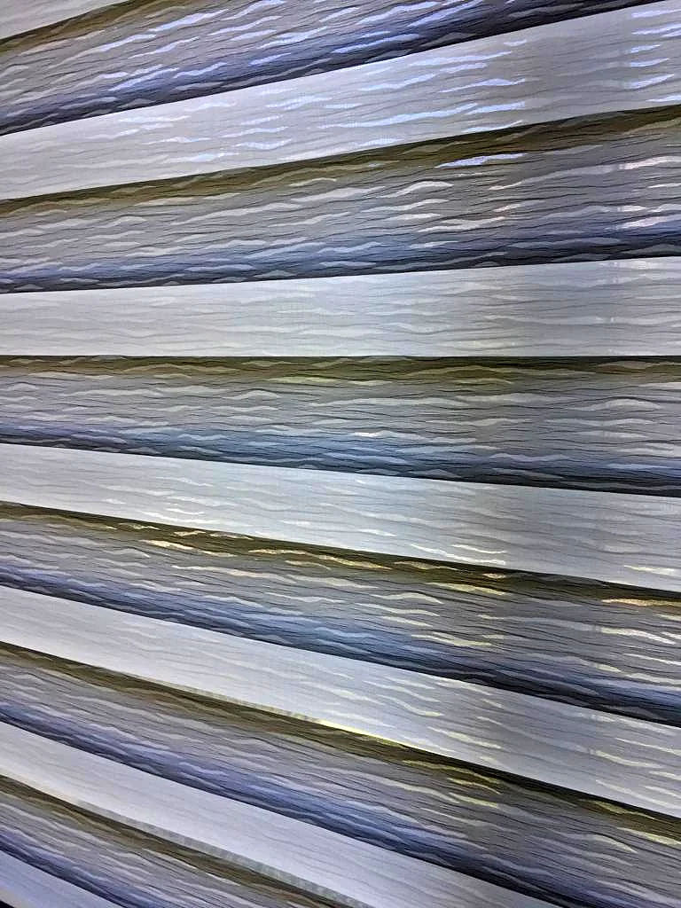 Close-up of a zebra shade, sheer and solid bands on one roller