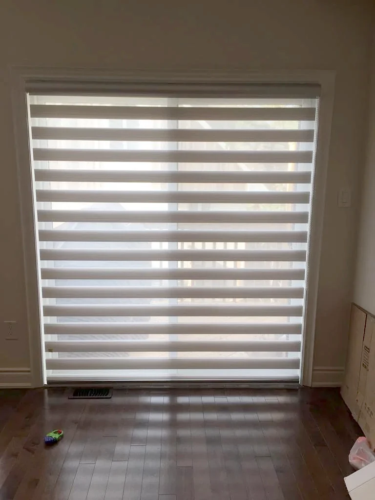 One zebra shade across a floor-to-ceiling opening