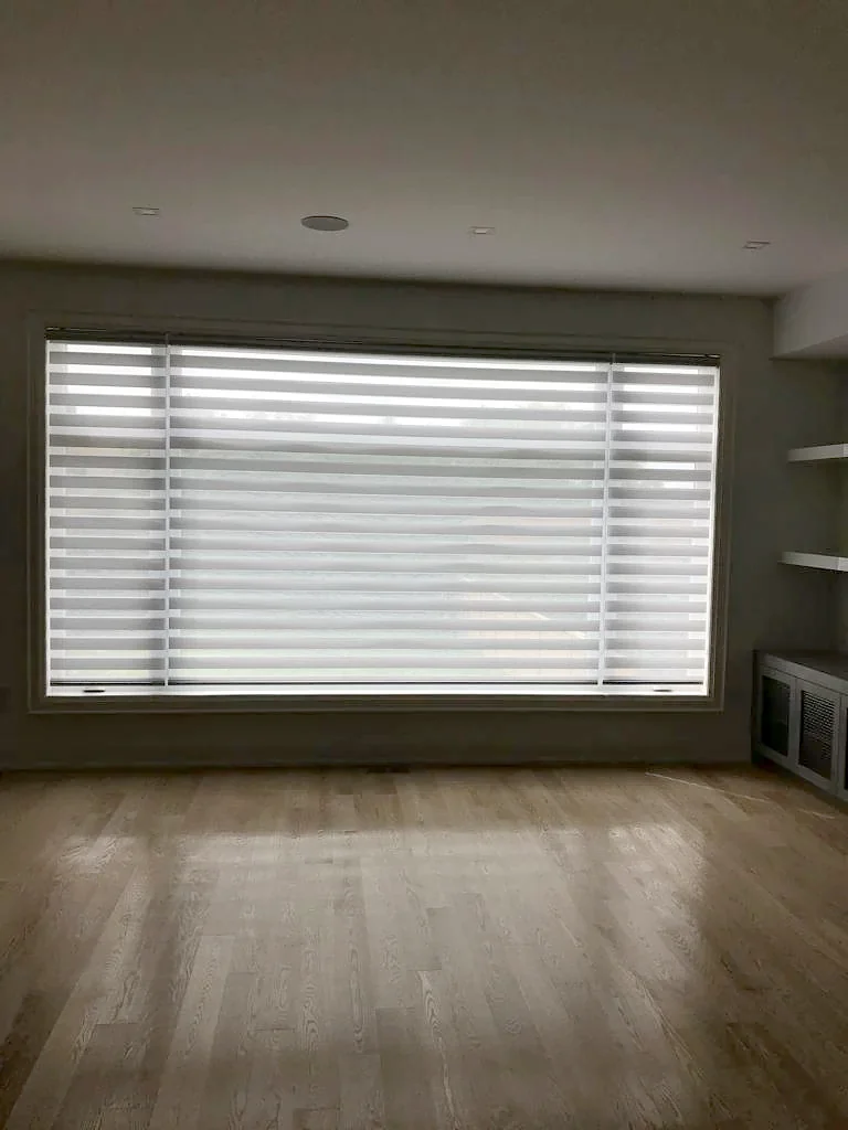 A zebra shade made to a window's opening and fitted inside its frame